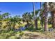 Beautiful Florida landscape with palm trees, a canal, and clear blue skies at 1449 Overhead St, North Port, FL 34288