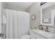 Bright bathroom featuring a shower with curtain, updated vanity, and ample counter space at 1449 Overhead St, North Port, FL 34288