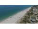 High-angle view of beachside, showcasing the boardwalk, white sands, and the vast blue Gulf of Mexico at 1449 Overhead St, North Port, FL 34288