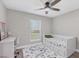 bedroom with twin bed, ceiling fan, and window views at 1449 Overhead St, North Port, FL 34288