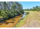 Canal view with lush greenery at 1449 Overhead St, North Port, FL 34288