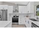 Modern kitchen with white cabinets, stainless steel appliances, and a bright subway tile backsplash at 1449 Overhead St, North Port, FL 34288