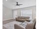 Bright living room with vaulted ceiling, ceiling fan, laminate floors, and two comfy couches at 1449 Overhead St, North Port, FL 34288