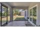Screened patio featuring tile flooring, fan, and views of the backyard at 1449 Overhead St, North Port, FL 34288