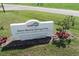 A sign for Warm Mineral Springs Park, nestled in a landscape of greenery at 1449 Overhead St, North Port, FL 34288