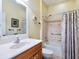 Well-maintained bathroom features large mirror, updated faucet and shower with curtain at 1545 Maseno Dr, Venice, FL 34292