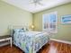 Light bedroom boasts wood floors, beach decor, and bright natural light at 1545 Maseno Dr, Venice, FL 34292