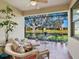 Enclosed lanai with comfortable seating and a view of the pond and landscaping at 1545 Maseno Dr, Venice, FL 34292