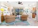 Cozy living area featuring rattan furniture, tropical rug, and a view of the screened lanai at 1545 Maseno Dr, Venice, FL 34292