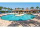 Large, inviting community pool with center fountain feature and covered lounge areas for relaxing and entertaining at 1545 Maseno Dr, Venice, FL 34292