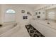 Bright bathroom with double vanity, garden tub, and natural light from arched window at 1572 Jasper Ct, Venice, FL 34292