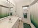 Bathroom with an extended vanity, marble flooring, and a glass-enclosed tub and shower at 1572 Jasper Ct, Venice, FL 34292