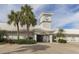 Waterford entrance features a clock tower, lush landscaping, and convenient covered parking at 1572 Jasper Ct, Venice, FL 34292