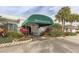 Waterford Golf Club entrance with a green awning, manicured landscaping, and a welcoming facade at 1572 Jasper Ct, Venice, FL 34292
