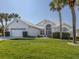 Beautiful single-story home with a well-manicured lawn and white tile roof at 1572 Jasper Ct, Venice, FL 34292
