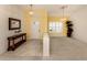 Bright foyer with tile flooring and chandelier, leading to a carpeted living area at 1572 Jasper Ct, Venice, FL 34292