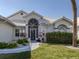 Charming front entrance with decorative plants and a tiled walkway at 1572 Jasper Ct, Venice, FL 34292