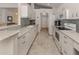 Bright kitchen with white cabinets, stainless steel appliances, and granite countertops at 1572 Jasper Ct, Venice, FL 34292