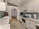 Bright kitchen with white cabinets, stainless steel appliances, tile backsplash and granite countertops at 1572 Jasper Ct, Venice, FL 34292