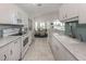 Bright kitchen with white cabinets, stainless steel appliances, tile backsplash and granite countertops at 1572 Jasper Ct, Venice, FL 34292