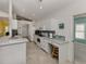 Bright kitchen features white cabinets, stainless steel appliances, tile backsplash and granite countertops at 1572 Jasper Ct, Venice, FL 34292