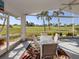 Screened lanai featuring outdoor seating and expansive views of a green lawn at 1572 Jasper Ct, Venice, FL 34292