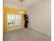 Open living area with bright yellow accent wall, chandelier, and plantation shutters at 1572 Jasper Ct, Venice, FL 34292