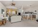 Open concept living room with bar seating, bright light and views into dining room at 1572 Jasper Ct, Venice, FL 34292