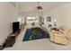 Open living room with vaulted ceiling, ceiling fan, and sliding glass doors to lanai at 1572 Jasper Ct, Venice, FL 34292