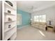 Bright living room with neutral carpet, and an accent teal colored wall with a view at 1572 Jasper Ct, Venice, FL 34292