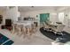 Spacious living room with bar seating adjacent to kitchen and view into the dining room at 1572 Jasper Ct, Venice, FL 34292