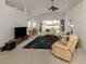 Spacious living room featuring vaulted ceiling, ceiling fan, and sliding glass doors at 1572 Jasper Ct, Venice, FL 34292