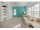 Bright living room with neutral carpet, and an accent teal colored wall at 1572 Jasper Ct, Venice, FL 34292