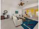 Bright living room with white sofas, colorful rug, and stylish decor at 1572 Jasper Ct, Venice, FL 34292