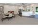 Well lit open concept lounge with a dining table and chairs and a white kitchenette at 1572 Jasper Ct, Venice, FL 34292