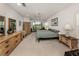 Spacious main bedroom with neutral carpet, ceiling fan and sliding glass doors to outdoor space at 1572 Jasper Ct, Venice, FL 34292