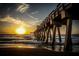 Wooden pier extending over the water, offering stunning ocean views and a sunset at 1572 Jasper Ct, Venice, FL 34292