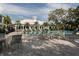 Exterior view of community pool with lounge chairs and view of the main building at 1572 Jasper Ct, Venice, FL 34292