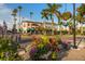 Beautiful street view showcases vibrant flowers and manicured landscaping in a tropical setting at 1572 Jasper Ct, Venice, FL 34292