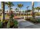 Inviting street view with decorative planters, palm trees, and well-maintained sidewalks at 1572 Jasper Ct, Venice, FL 34292