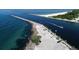 Breathtaking aerial view of a waterfront area featuring piers, boaters, and beach access at 1572 Jasper Ct, Venice, FL 34292