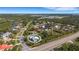 An aerial shot of the property, highlighting its location within a neighborhood with mature trees and lush foliage at 1596 Landfall Dr, Nokomis, FL 34275