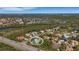 Aerial view of the property in a community with waterways and mature trees, close to Tamiami Trail at 1596 Landfall Dr, Nokomis, FL 34275