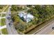 An aerial view showcasing the property's location on a corner lot with mature trees and lush greenery at 1596 Landfall Dr, Nokomis, FL 34275