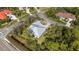 An aerial perspective of the property showcasing its position on a tree-lined corner lot in a residential area at 1596 Landfall Dr, Nokomis, FL 34275