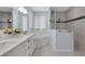 Modern bathroom with a double vanity, soaking tub, and glass-enclosed shower at 1596 Landfall Dr, Nokomis, FL 34275