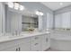 Elegant bathroom featuring a double vanity with quartz countertop and a separate tub at 1596 Landfall Dr, Nokomis, FL 34275