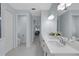 Hall bathroom with double sinks, and tile floors at 1596 Landfall Dr, Nokomis, FL 34275