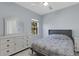 Bedroom featuring a comfortable bed, dresser with mirror, ceiling fan, and natural light at 1596 Landfall Dr, Nokomis, FL 34275