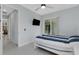Bedroom featuring a ceiling fan, bed, sliding glass doors to the lanai, and neutral decor at 1596 Landfall Dr, Nokomis, FL 34275